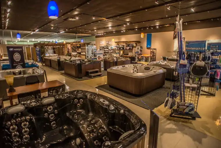 The Columbia showroom floor with hot tubs on display and pool supplies along the wall
