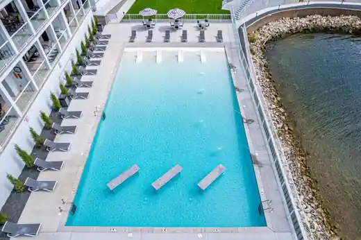 Aerial view of a rectangular resort pool with sun-shelf loungers