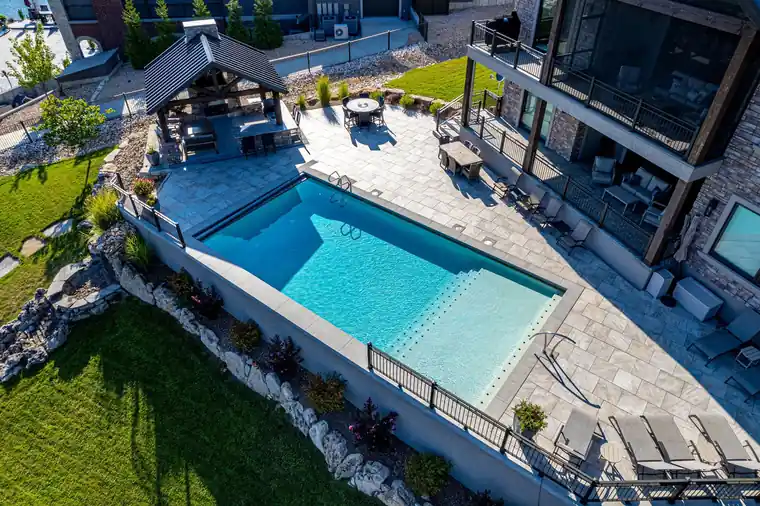 Aerial view of a terraced lakeside pool and patio