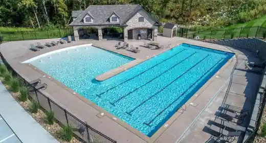 Aerial view of a lap pool with a pool house
