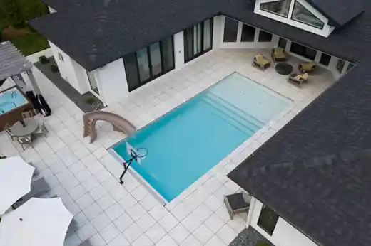 Modern home with a rectangular pool and steps