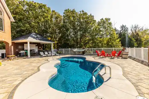 Freeform pool with a gazebo and patio