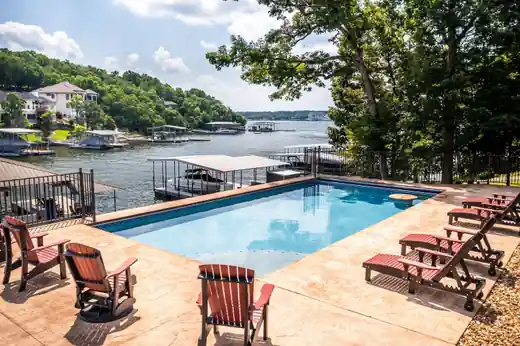 Wide view of the same lake pool with dock beyond