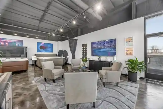 Inside the Osage Beach showroom: Jacuzzi hot tubs on display beside a seating area under track lighting