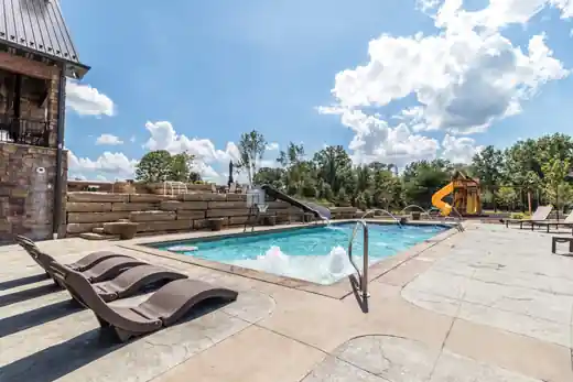 Pool with a slide and sun loungers